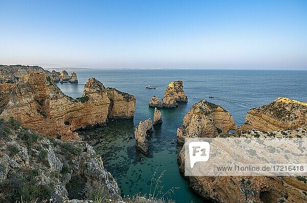 Rugged rocky coast with cliffs of sandstone  rock formations in the sea  Ponta da Piedade  at sunset  Algarve  Lagos  Portugal  Europe