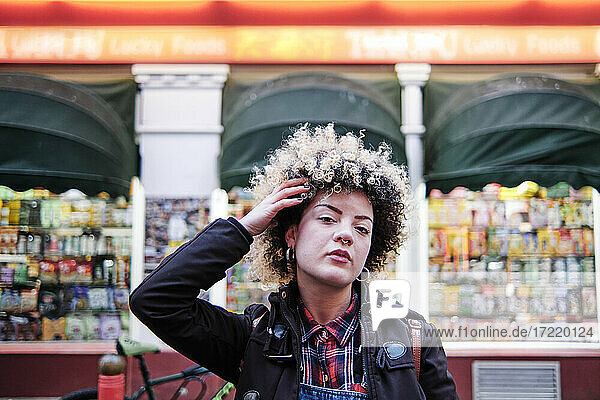 Hipster woman with hand in hair at Chinatown