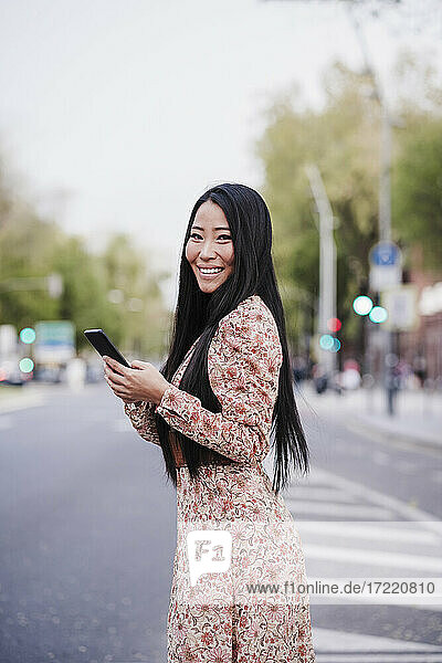 Beautiful woman with smart phone in city