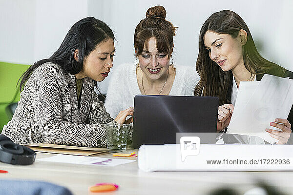 Young female entrepreneurs working on laptop at office