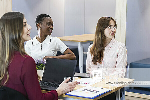 Female entrepreneurs looking away in meeting at office