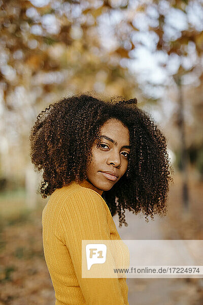 Afro woman in park during autumn