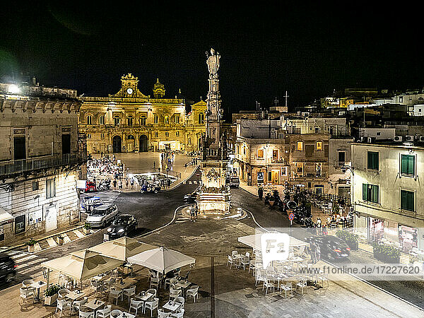 Italy  Province of Brindisi  Ostuni  Column of Saint Orontius standing in middle of illuminated town square at night