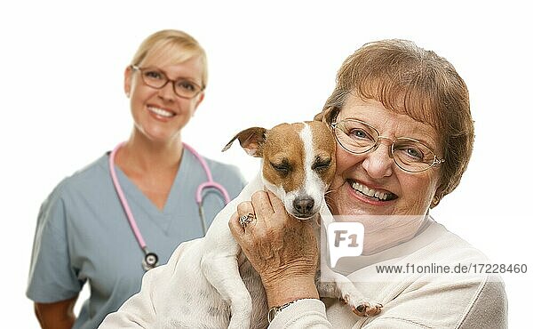 Happy senior woman with her dog and veterinarian behind isolated on a white background