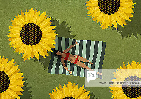 Frau im Bikini Sonnenbaden auf Decke unter großen Sonnenblumen