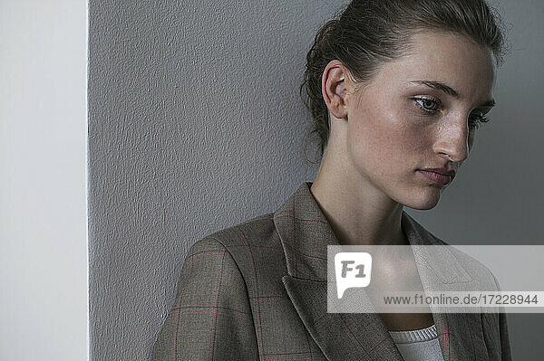 Portrait beautiful serene young businesswoman looking down