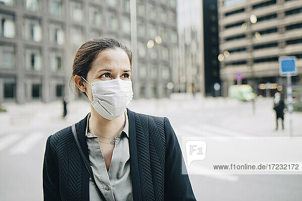 Geschäftsfrau  die auf der Straße in der Stadt während der Pandemie wegschaut