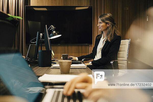 Female lawyer working on computer in board room at office
