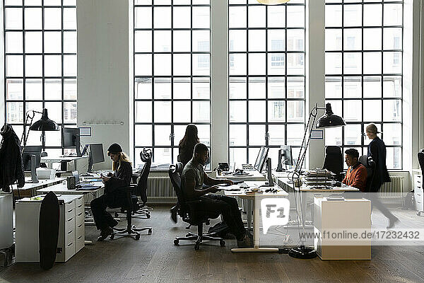 Business people working at desk in creative office