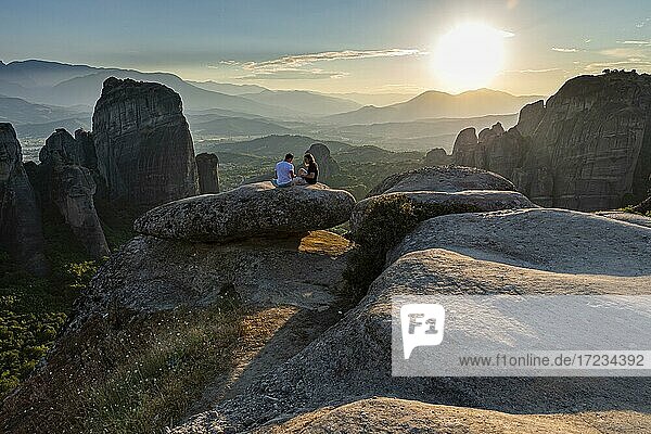 Men watching the sunset over the Meteora monastery  Thessaly  Greece  Europe