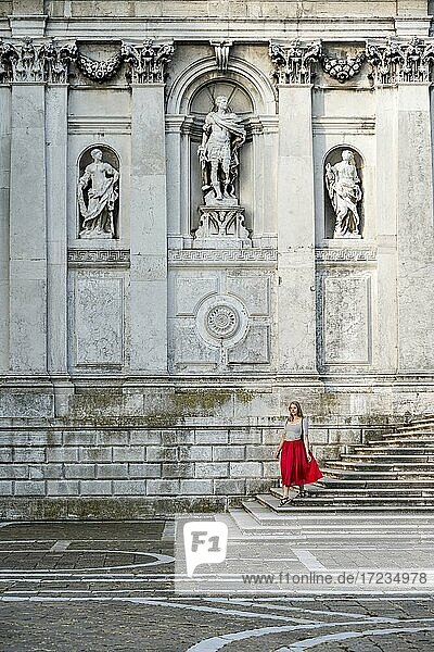Young woman with red dress in front of white church  Basilica di Santa Maria della Salute  Venice  Veneto  Italy  Europe