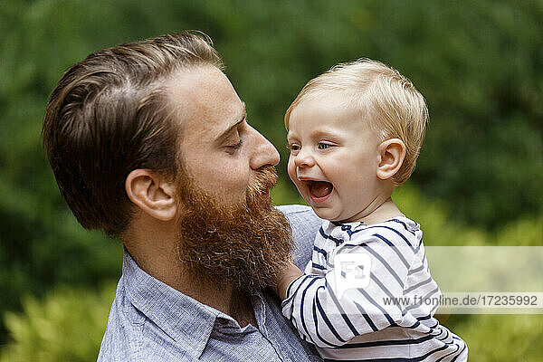 Portrait of father and baby girl  outdoors  laughing