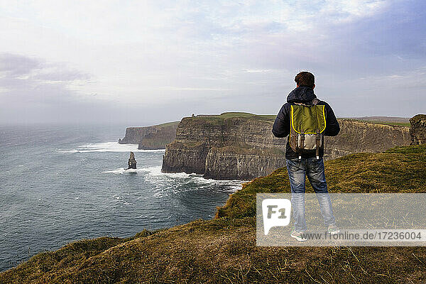 Mid adult man standing on The Cliffs of Moher  The Burren  County Clare  Ireland