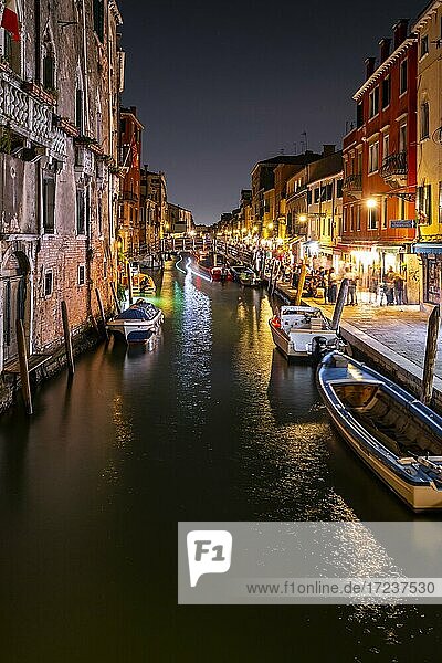Evening atmosphere  streetlights  canal with boats and historical buildings  light traces  Venice  Veneto  Italy  Europe