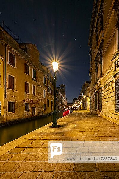 Evening atmosphere  streetlights  canal and historical buildings  Venice  Veneto  Italy  Europe