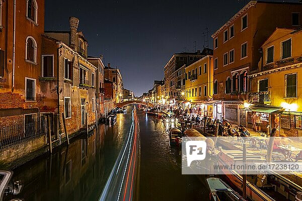 Canal with boats and historical buildings  light traces  Venice  Veneto  Italy  Europe