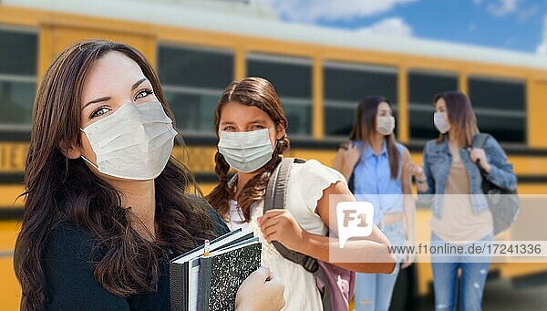 Students near school bus wearing medical face masks during coronavirus pandemic