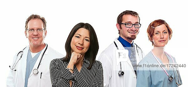 Attractive hispanic woman with male and female doctors or nurses before a white background