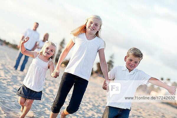 Adorable caucasian family on a walk at the beach