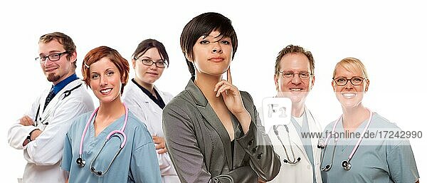 Young mixed race woman with doctors and nurses behind isolated on a white background