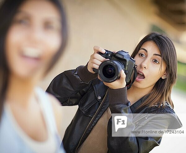 Excited and ready female mixed-race photographer spots celebrity outside