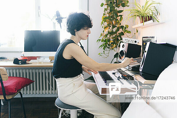 Female musician playing piano at studio