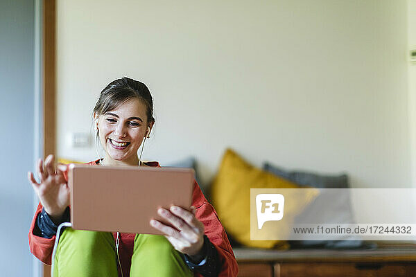 Beautiful young woman using digital tablet at home