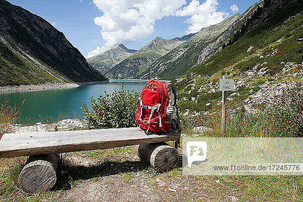 Backpack on wooden bench during sunny day at Zillertal  Austria