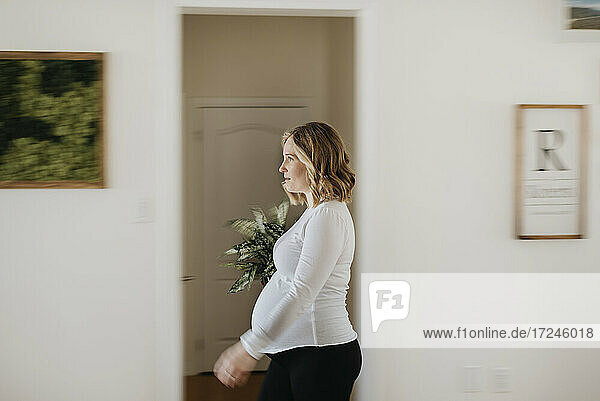 Young woman walking through living room at home