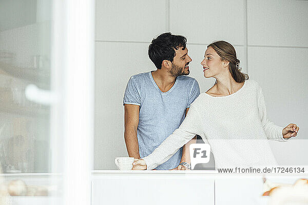 Romantic young couple in kitchen at home