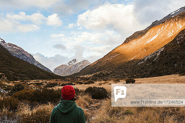 Male hiker standing and admiring beauty of Arthurs Pass  South Island  New Zealand
