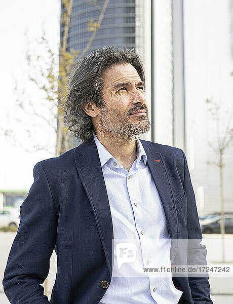 Mature businessman while contemplating looking away