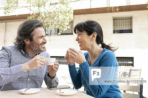 Glückliches reifes Paar lächelnd bei einem Kaffee auf der Terrasse