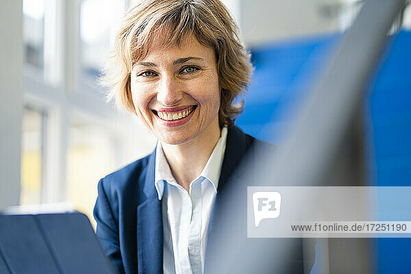Lächelnde reife Geschäftsfrau mit digitalem Tablet