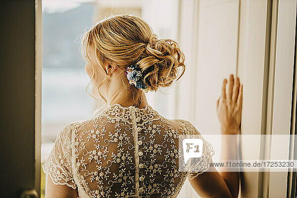 Blonde Braut mit Haarknoten im Hochzeitskleid