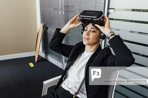 Entrepreneur with virtual reality headset in office