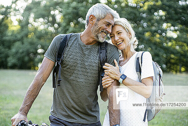Smiling mature couple standing in forest
