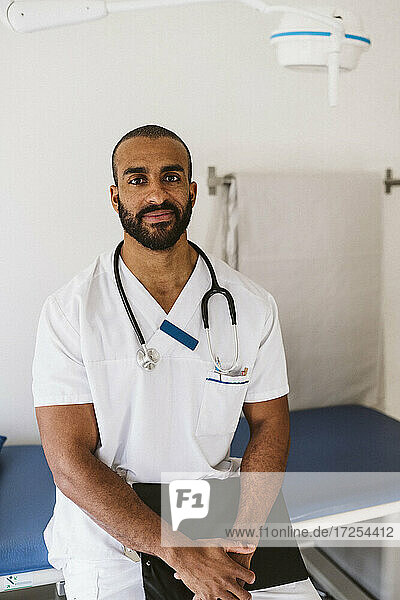 Portrait of male healthcare worker standing with medical file