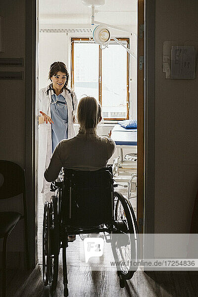 Disabled woman visiting female doctor at medical clinic