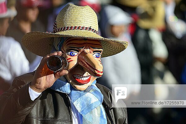 Mask of a man with a beer bottle at the parade on the eve of Inti Raymi  Festival of the Sun