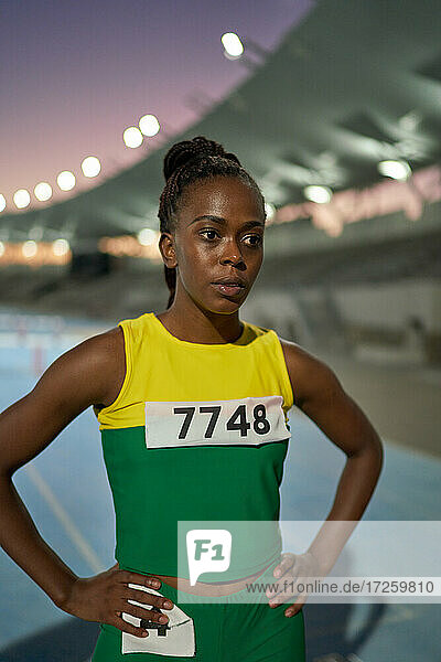 Portrait tough female track and field athlete at competition