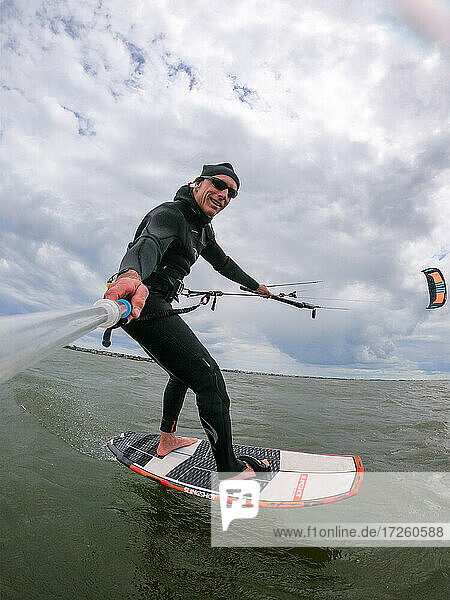 Photographer Skip Brown on his foiling kiteboard on the Pamlico Sound  Nags Head  North Carolina  United States of America  North America