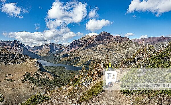 Hikers on the trail to Scenic Point  view of Two Medicine Lake  mountain peaks Rising Wolf Mountain and Sinopah Mountain  Glacier National Park  Montana  USA  North America