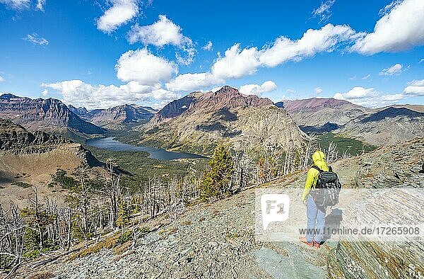 Hikers on the trail to Scenic Point  view of Two Medicine Lake  mountain peaks Rising Wolf Mountain and Sinopah Mountain  Glacier National Park  Montana  USA  North America