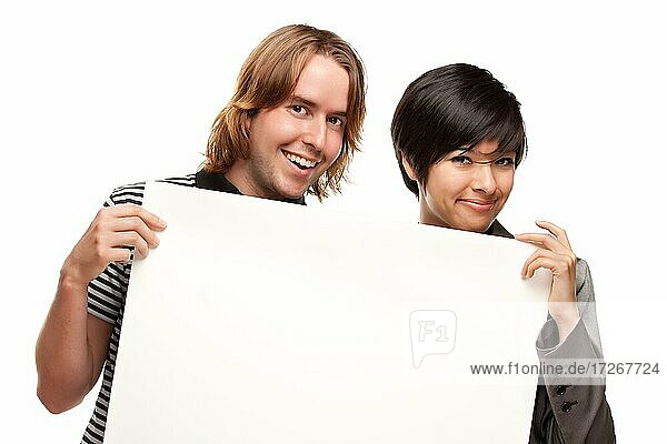 Attractive diverse couple holding blank white sign isolated on a white background