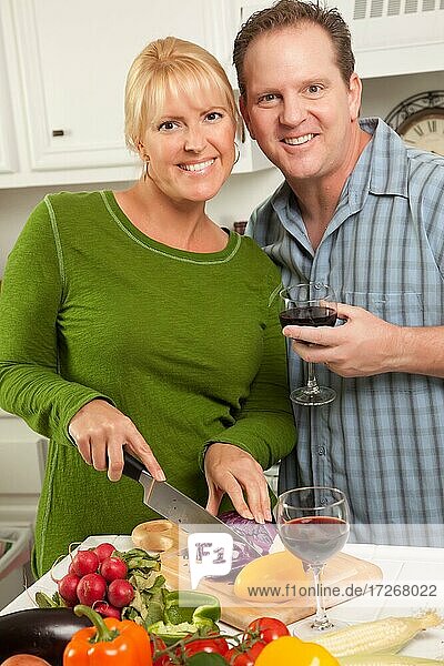 Happy couple enjoying an evening preparing food in the kitchen