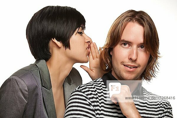Attractive diverse couple whispering secrets isolated on a white background