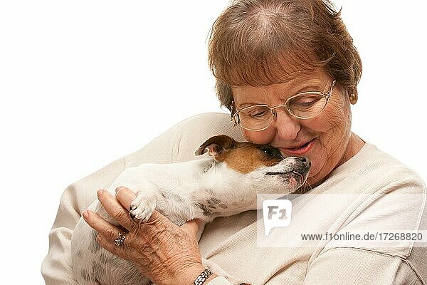 Happy attractive senior woman with puppy isolated on a white background