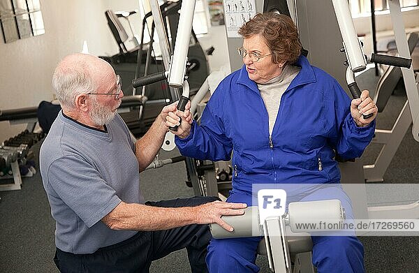 Senior adult couple working out in the gym