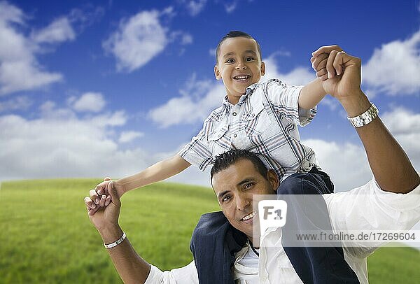 Hispanic father and son having fun together in the park